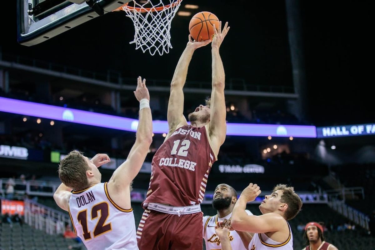 Nov 23, 2023; Kansas City, Missouri, USA; Boston College Eagles forward Quinten Post (12) goes after a rebound during the first half against the Loyola (Il) Ramblers at T-Mobile Center.