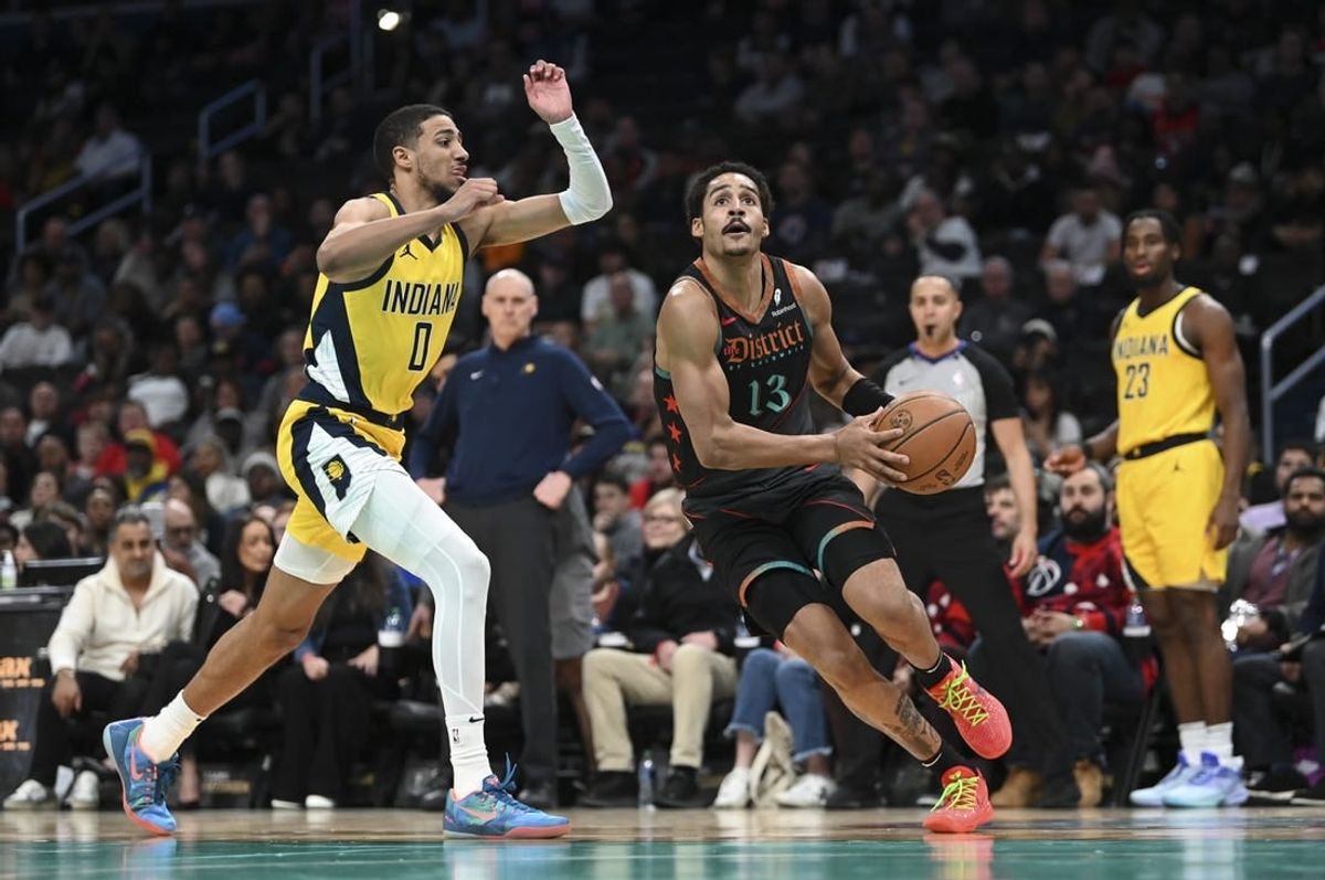 Dec 15, 2023; Washington, District of Columbia, USA;Washington Wizards guard Jordan Poole (13) makes a move to the basket by Indiana Pacers guard Tyrese Haliburton (0) during the first half   at Capital One Arena.