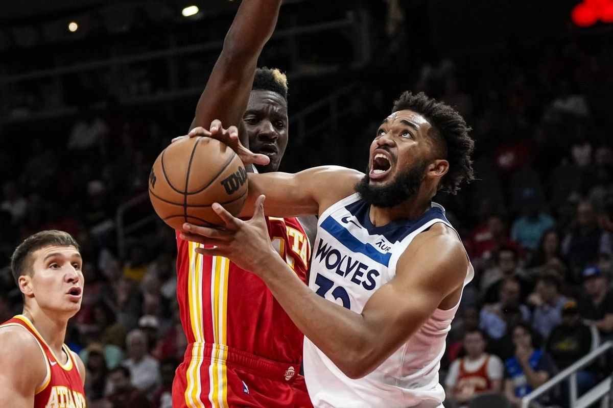 Oct 30, 2023; Atlanta, Georgia, USA; Minnesota Timberwolves center Karl-Anthony Towns (32) tries to get to the basket against Atlanta Hawks center Clint Capela (15) during the first half at State Farm Arena.