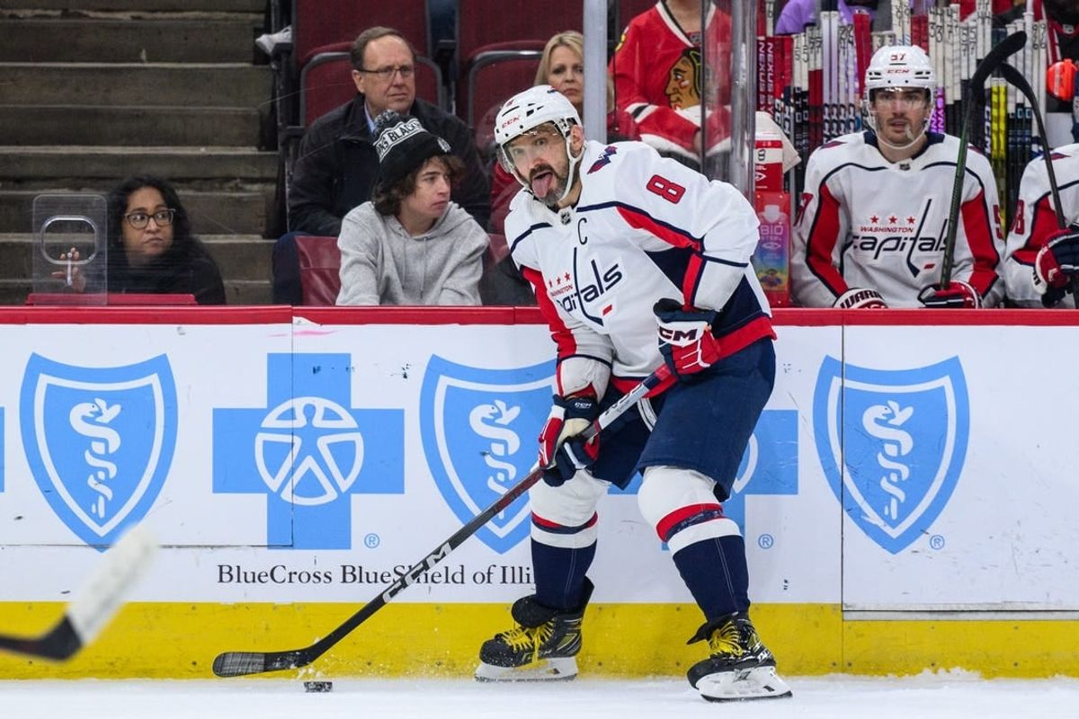 Dec 10, 2023; Chicago, Illinois, USA; Washington Capitals left wing Alex Ovechkin (8) plays the puck against the Chicago Blackhawks during the first period at the United Center.