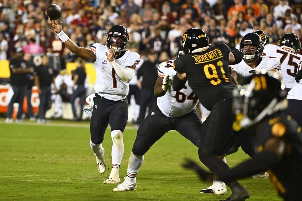 Oct 5, 2023; Landover, Maryland, USA; Chicago Bears quarterback Justin Fields (1) passes the ball as Washington Commanders defensive tackle John Ridgeway (91) defends during the first half at FedExField.