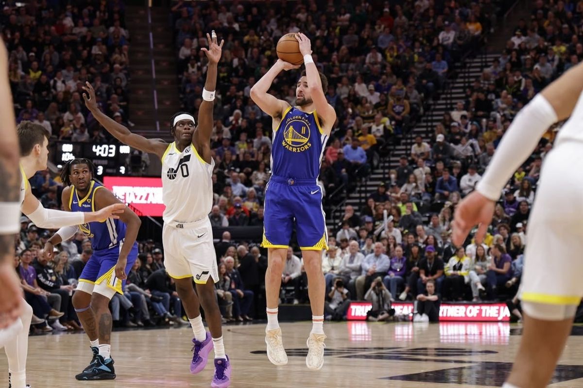 Feb 15, 2024; Salt Lake City, Utah, USA; Golden State Warriors guard Klay Thompson (11) shoots as Utah Jazz forward Taylor Hendricks (0) defends during the second half at Delta Center.