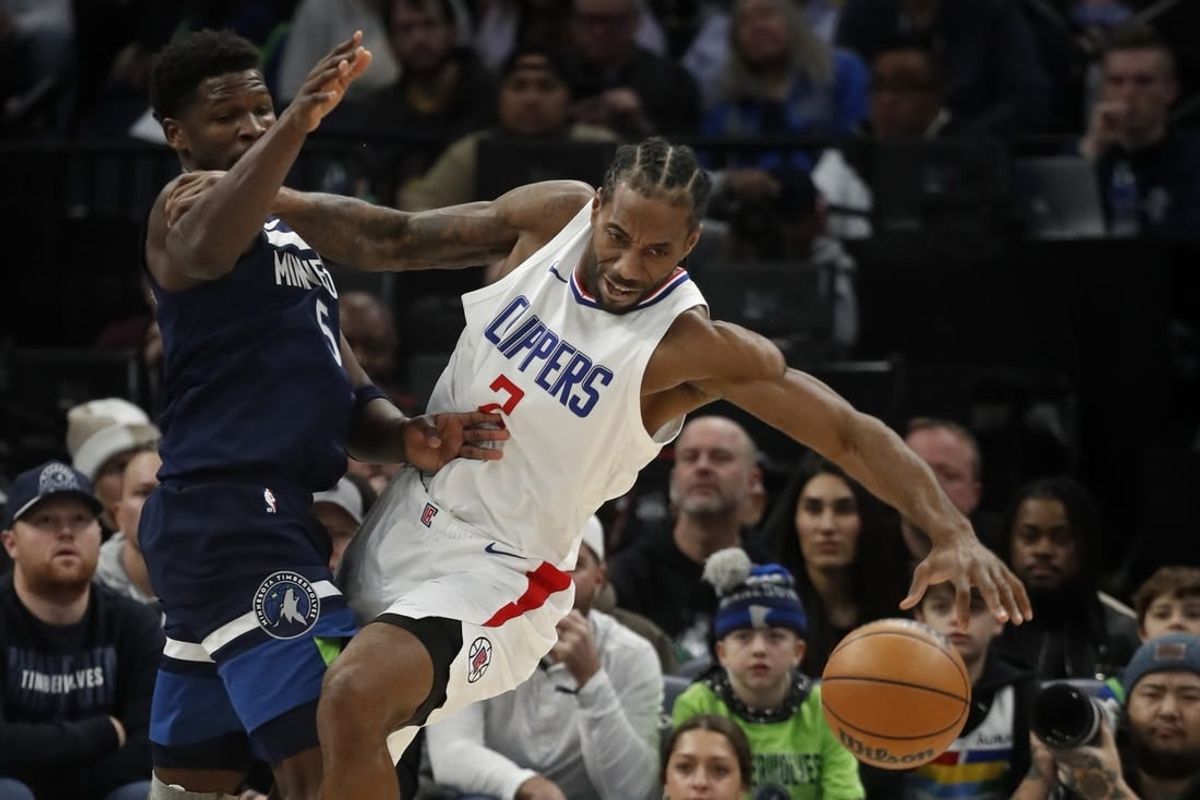 Jan 14, 2024; Minneapolis, Minnesota, USA; Minnesota Timberwolves guard Anthony Edwards (5) defends against Los Angeles Clippers forward Kawhi Leonard (2) in the first quarter at Target Center.