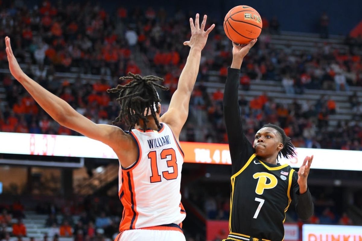 Dec 30, 2023; Syracuse, New York, USA; Pittsburgh Panthers guard Carlton Carrington (7) shoots as Syracuse Orange forward Benny Williams (13) defends during the first half at the JMA Wireless Dome.