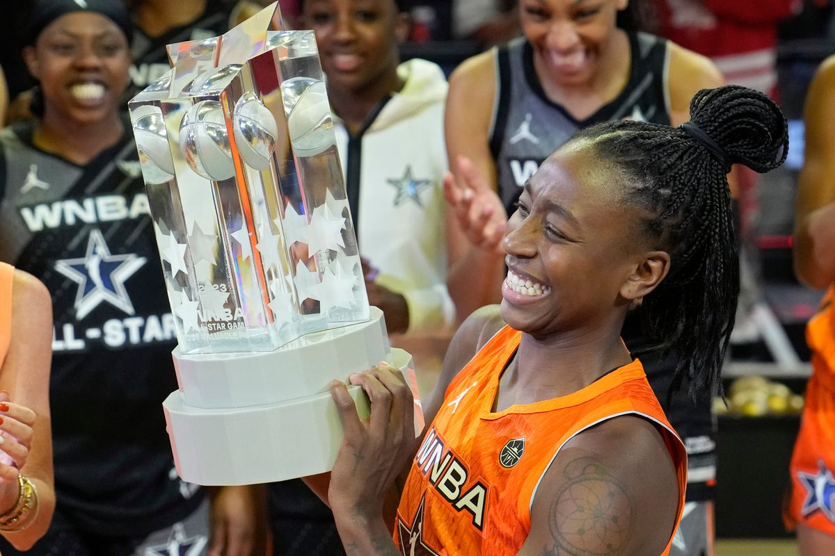 Jewell L oyd hoists a much more pleasant-looking All-Star MVP trophy.