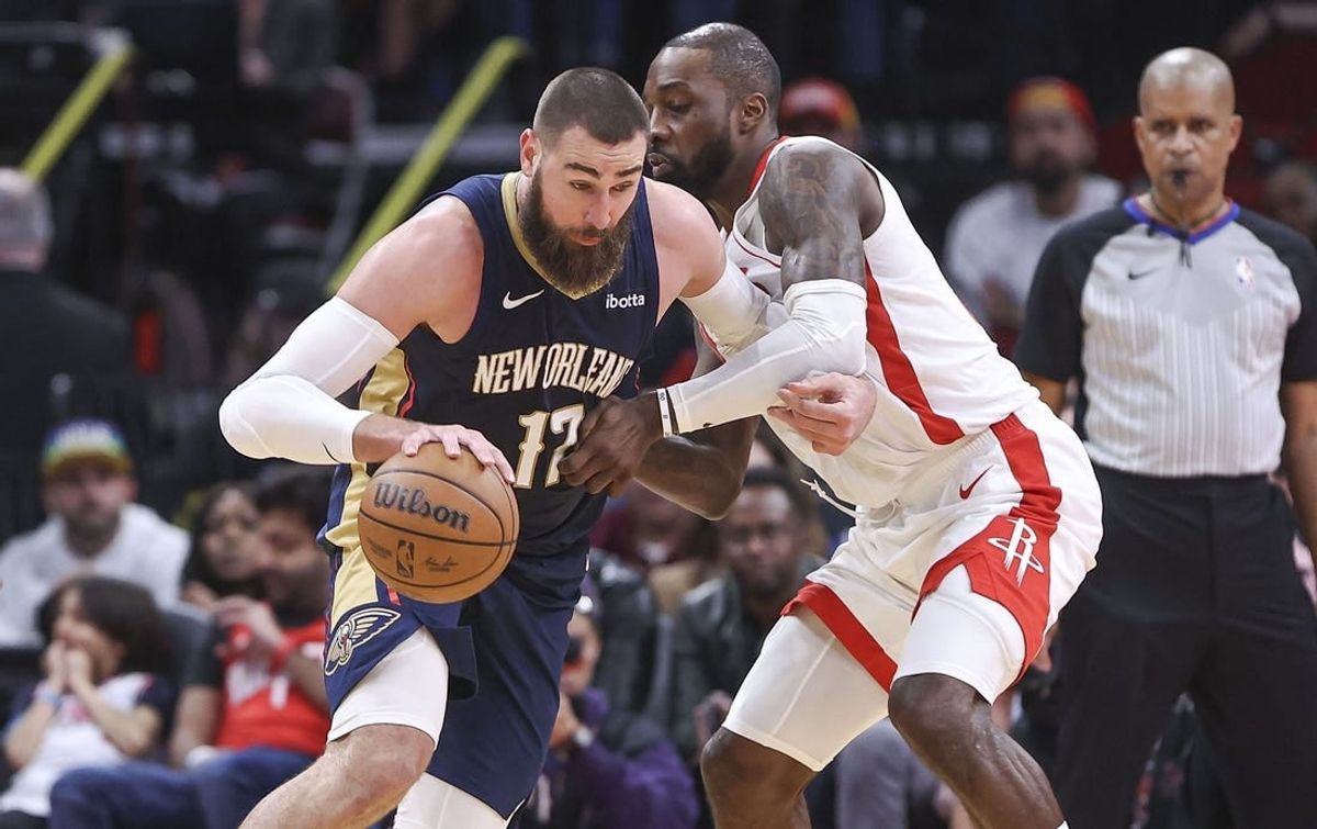 Jan 31, 2024; Houston, Texas, USA; New Orleans Pelicans center Jonas Valanciunas (17) controls the ball as Houston Rockets forward Jeff Green (32) defends during the fourth quarter at Toyota Center.