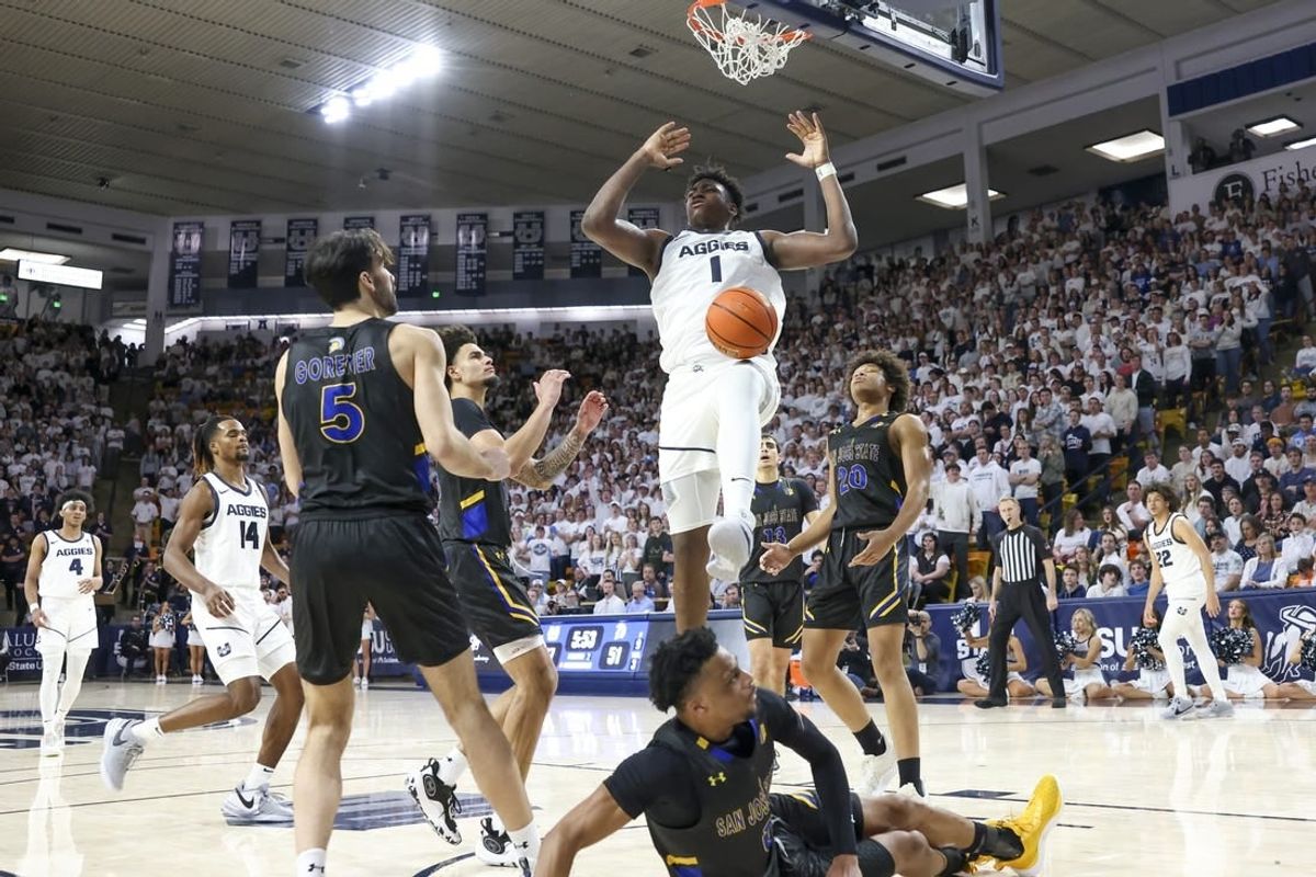 Jan 30, 2024; Logan, Utah, USA; Utah State Aggies forward Great Osobor (1) dunks the ball against the San Jose State Spartans during the second half at Dee Glen Smith Spectrum.