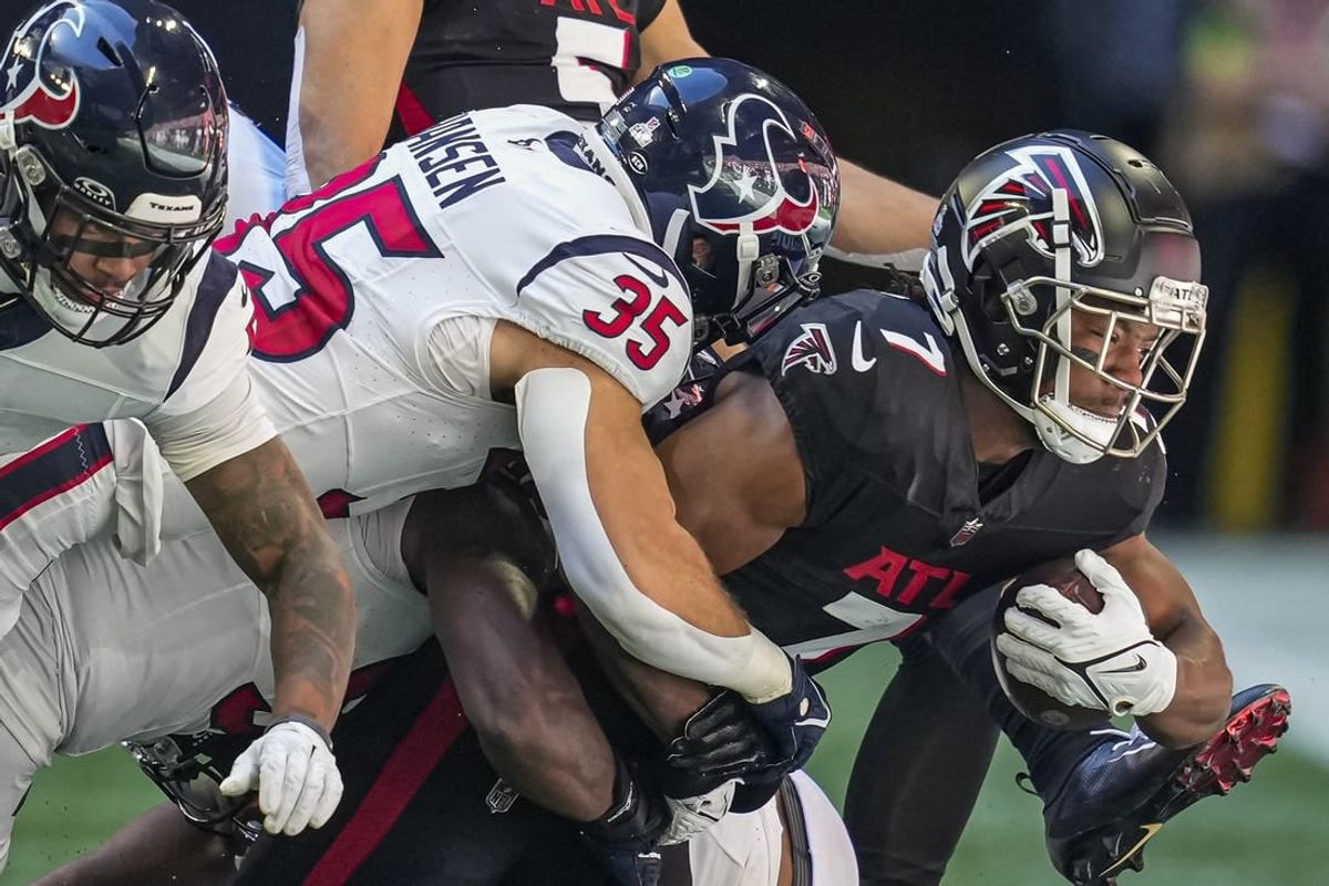 Oct 8, 2023; Atlanta, Georgia, USA; Atlanta Falcons running back Bijan Robinson (7) is tackled by Houston Texans linebacker Jake Hansen (35) during the first half at Mercedes-Benz Stadium.