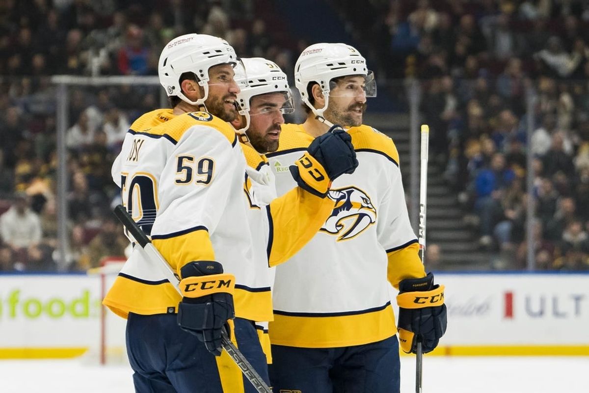 Oct 31, 2023; Vancouver, British Columbia, CAN; Nashville Predators defenseman Roman Josi (59) and defenseman Dante Fabbro (57) and forward Filip Forsberg (9) celebrate Fabbro   s goal against the Vancouver Canucks in the first period at Rogers Arena.