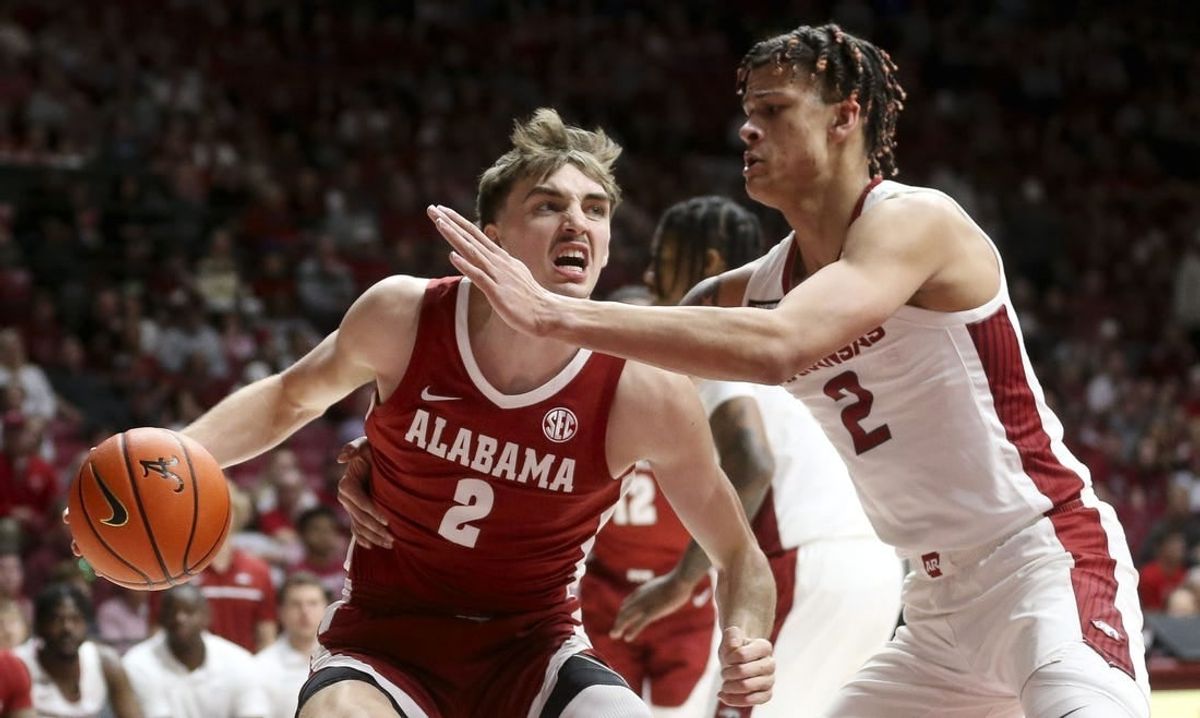 Mar 9, 2024; Tuscaloosa, Alabama, USA;  Alabama Crimson Tide forward Grant Nelson (2) drives against Arkansas Razorbacks forward Trevon Brazile (2) at Coleman Coliseum.