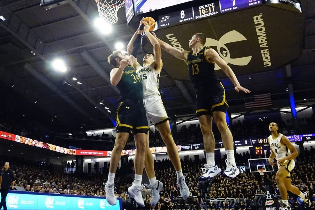 Dec 1, 2023; Evanston, Illinois, USA; Northwestern Wildcats center Matthew Nicholson (34) defends Purdue Boilermakers center Zach Edey (15) during the first half at Welsh-Ryan Arena.