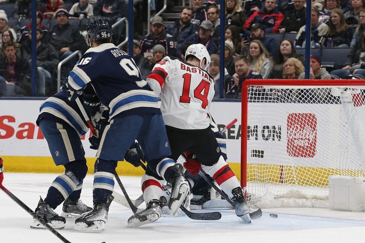 Jan 19, 2024; Columbus, Ohio, USA; New Jersey Devils right wing Nathan Bastian (14) tips the puck past Columbus Blue Jackets goalie Elvis Merzlikins (90) for a goal during the second period at Nationwide Arena.
