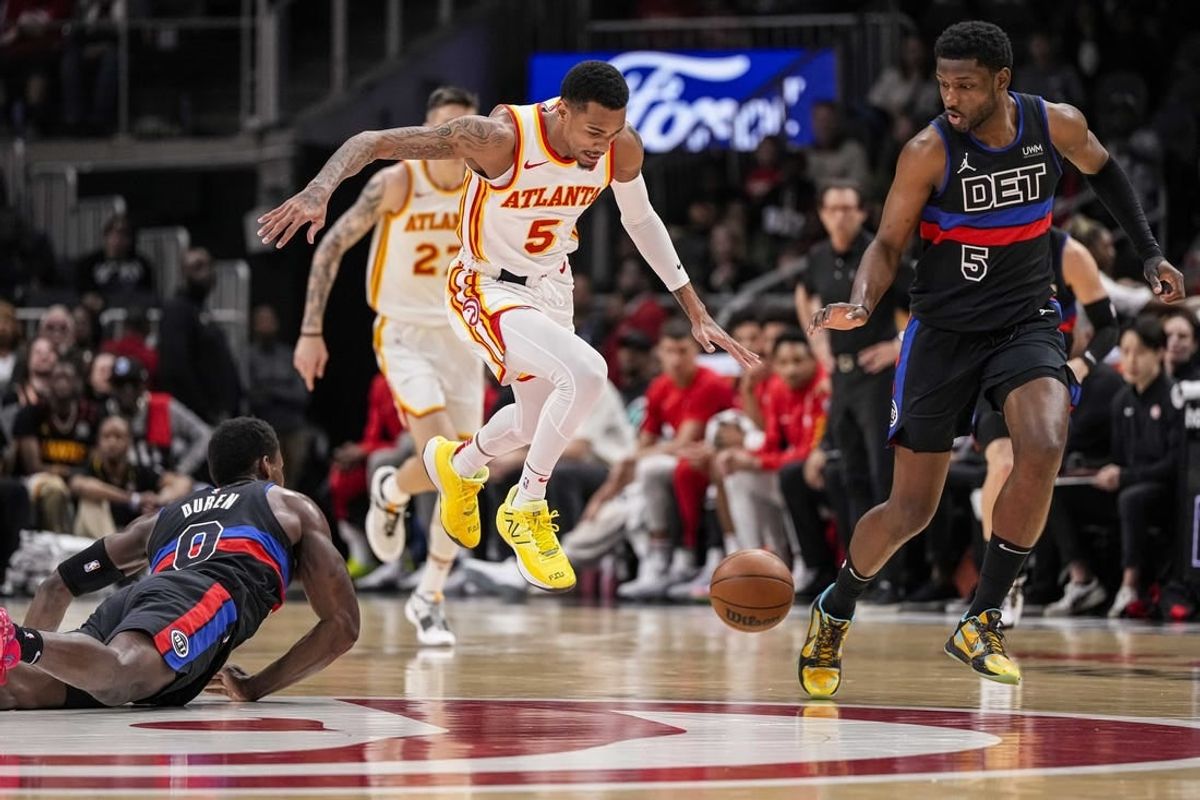 Apr 3, 2024; Atlanta, Georgia, USA; Atlanta Hawks guard Dejounte Murray (5) tries to control a loose ball between Detroit Pistons center Jalen Duren (0) and guard Jaylen Nowell (5) during the first half at State Farm Arena.
