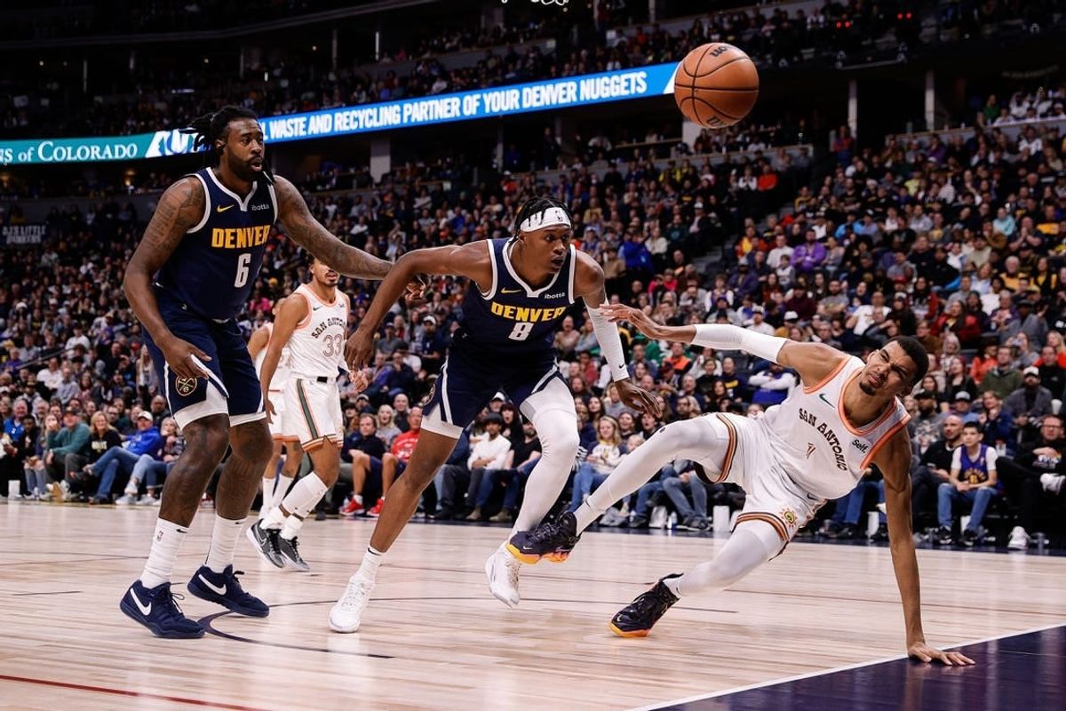 Nov 26, 2023; Denver, Colorado, USA; Denver Nuggets center DeAndre Jordan (6) and forward Peyton Watson (8) and San Antonio Spurs center Victor Wembanyama (1) watch for a loose ball in the second quarter at Ball Arena.