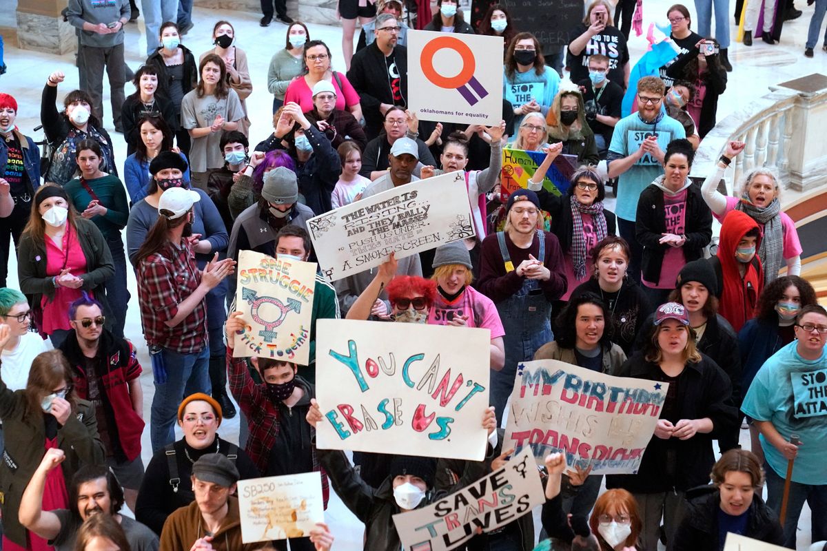 Trans-rights activ ists protest outside the House chamber at the state Capitol before the State of the State address Monday, Feb. 6, 2023, in Oklahoma City.