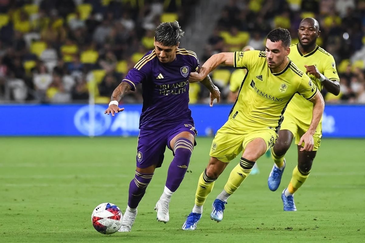 Oct 4, 2023; Nashville, Tennessee, USA; Orlando City forward Facundo Torres (17) dribbles the ball as Nashville SC defender Daniel Lovitz (2) defends during the first half at Geodis Park.