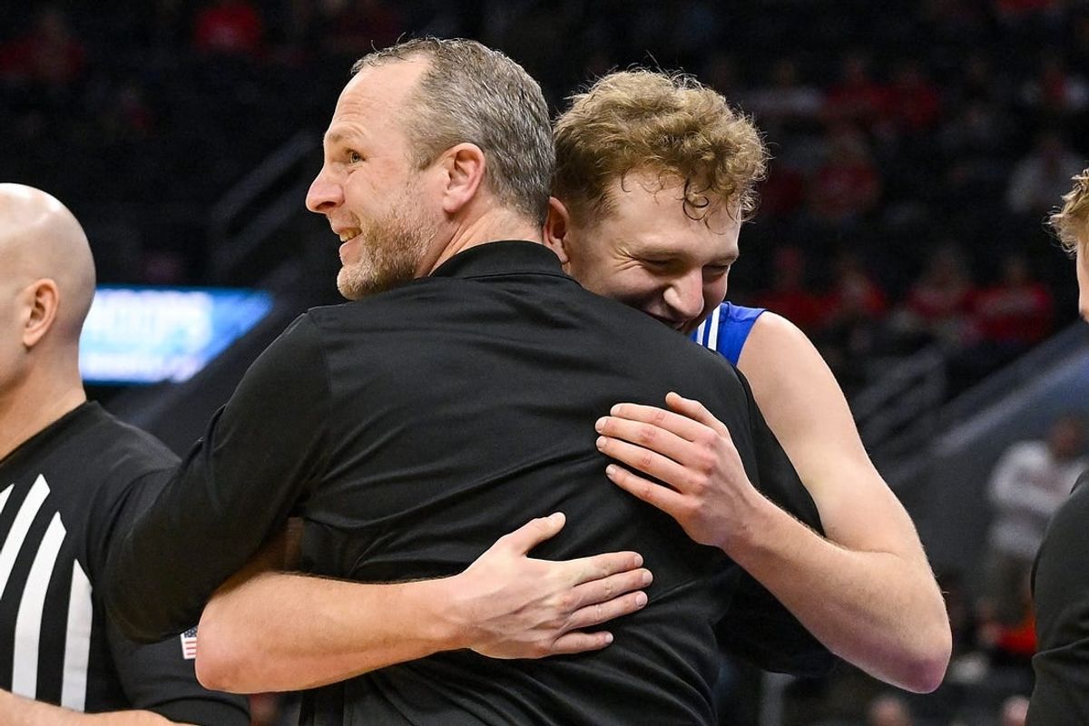 Mar 5, 2023; St. Louis, MO, USA; Drake Bulldogs guard Tucker DeVries (12) celebrates with head coach Darian DeVries during the second half against the Bradley Braves in the finals of the Missouri Valley Conference Tournament at Enterprise Center.