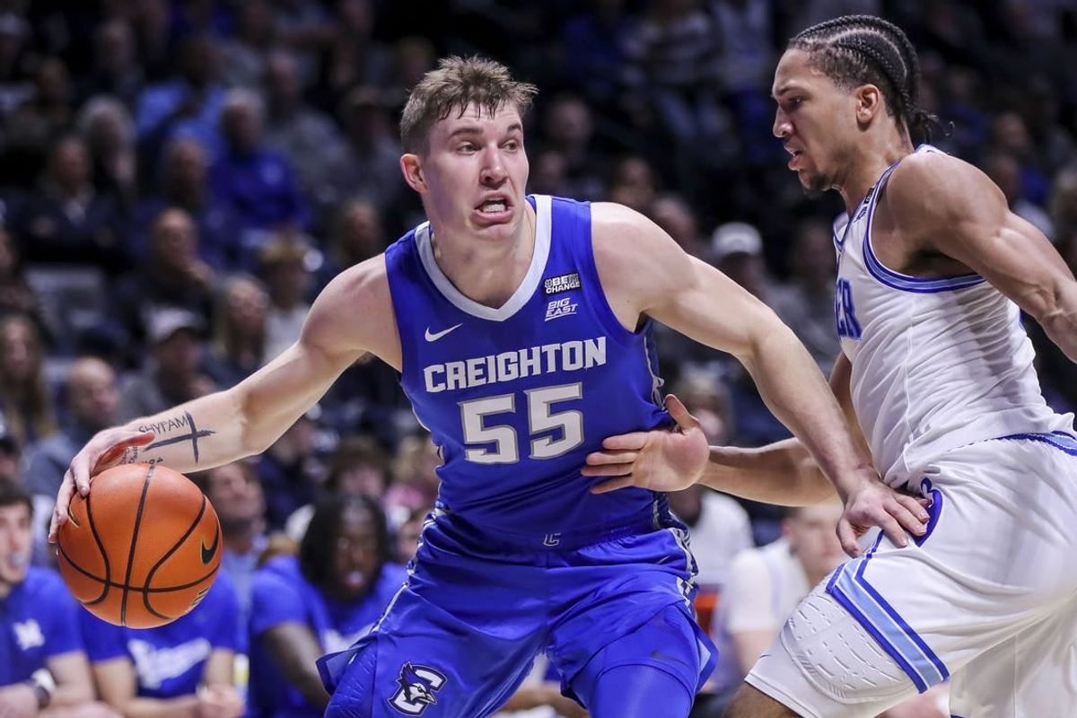 Feb 10, 2024; Cincinnati, Ohio, USA; Creighton Bluejays guard Baylor Scheierman (55) dribbles against Xavier Musketeers guard Desmond Claude (1) in the first half at Cintas Center.