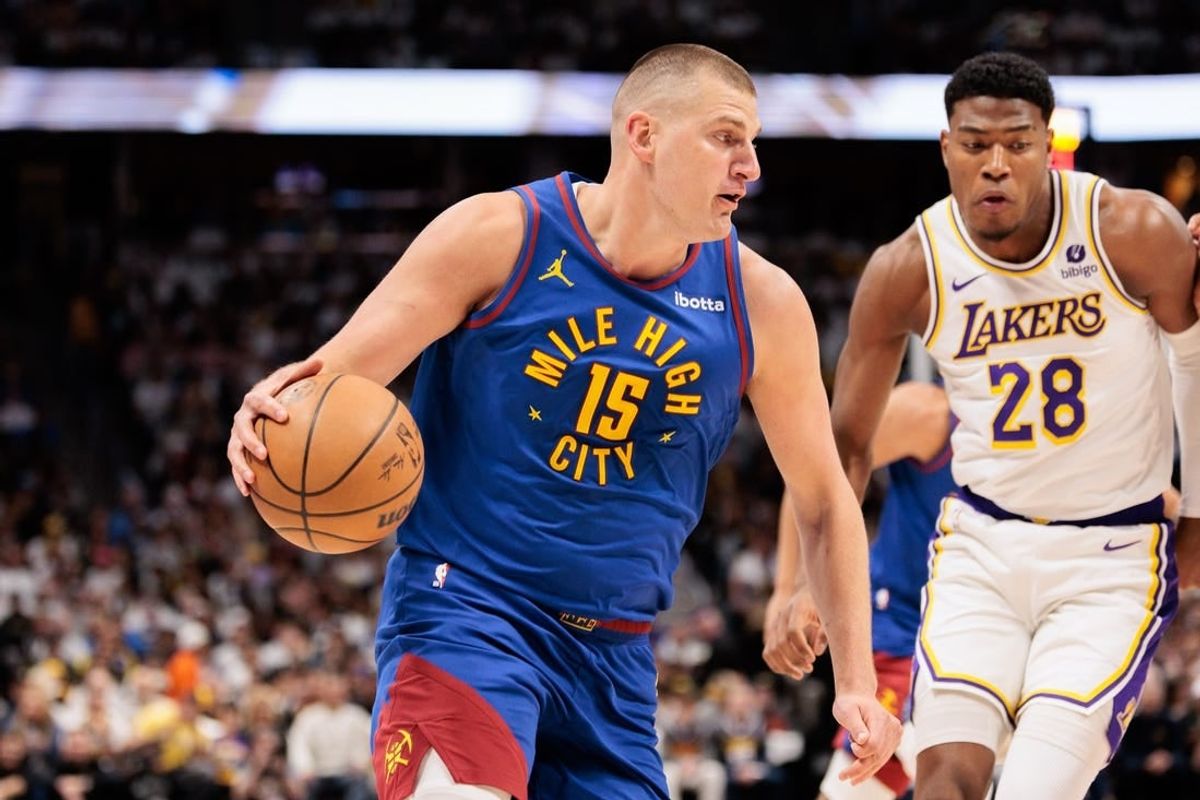Apr 20, 2024; Denver, Colorado, USA; Denver Nuggets center Nikola Jokic (15) drives to the basket against Los Angeles Lakers forward Rui Hachimura (28) during the first quarter in game one of the first round for the 2024 NBA playoffs at Ball Arena.