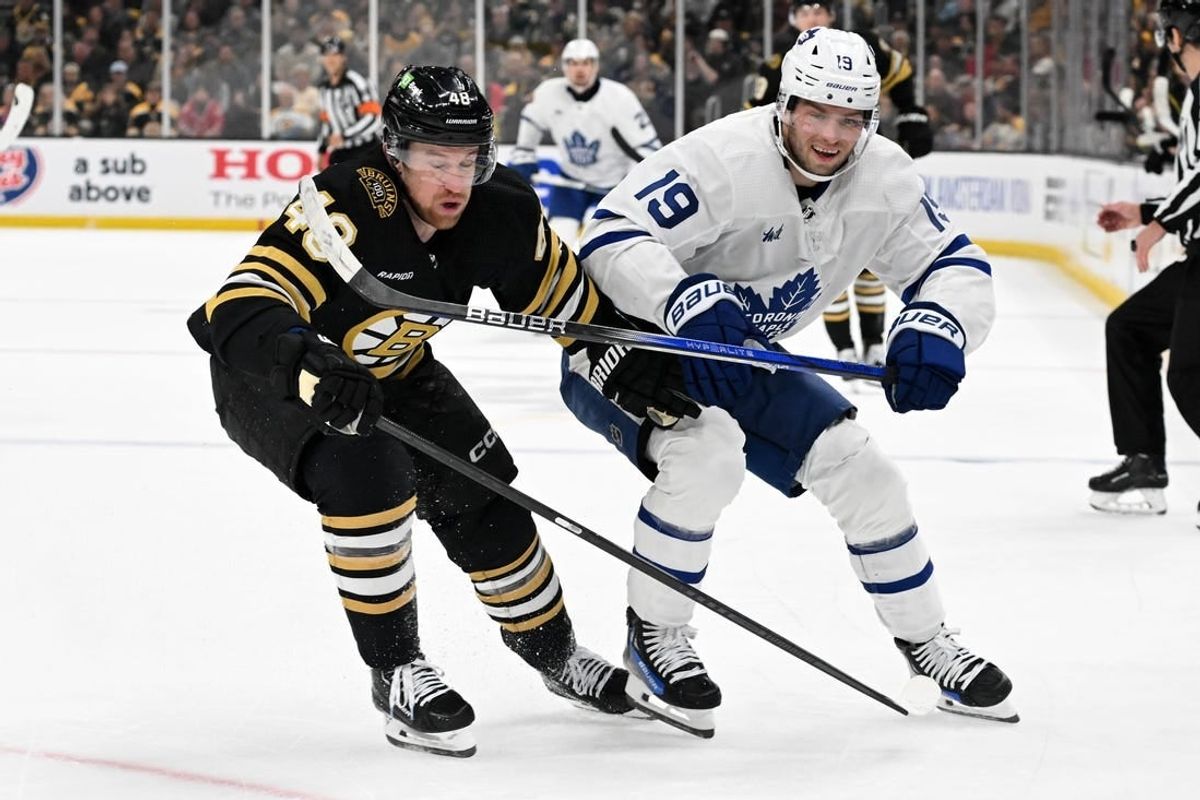Apr 22, 2024; Boston, Massachusetts, USA; Boston Bruins defenseman Matt Grzelcyk (48) and Toronto Maple Leafs center Calle Jarnkrok (19) battle for the puck during the second period in game two of the first round of the 2024 Stanley Cup Playoffs at TD Garden.
