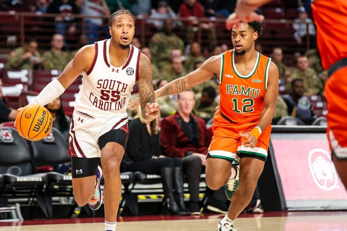 Dec 30, 2023; Columbia, South Carolina, USA; South Carolina Gamecocks guard Ta'Lon Cooper (55) drives around Florida A&M Rattlers guard K'Jei Parker (12) in the first quarter at Colonial Life Arena.