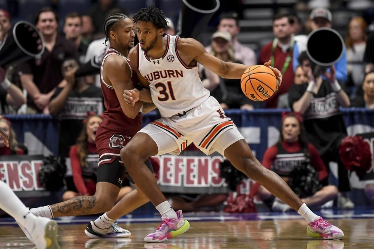 Mar 15, 2024; Nashville, TN, USA; Auburn Tigers guard Chaney Johnson (31) backs down South Carolina Gamecocks forward Josh Gray (33) during the first half at Bridgestone Arena.