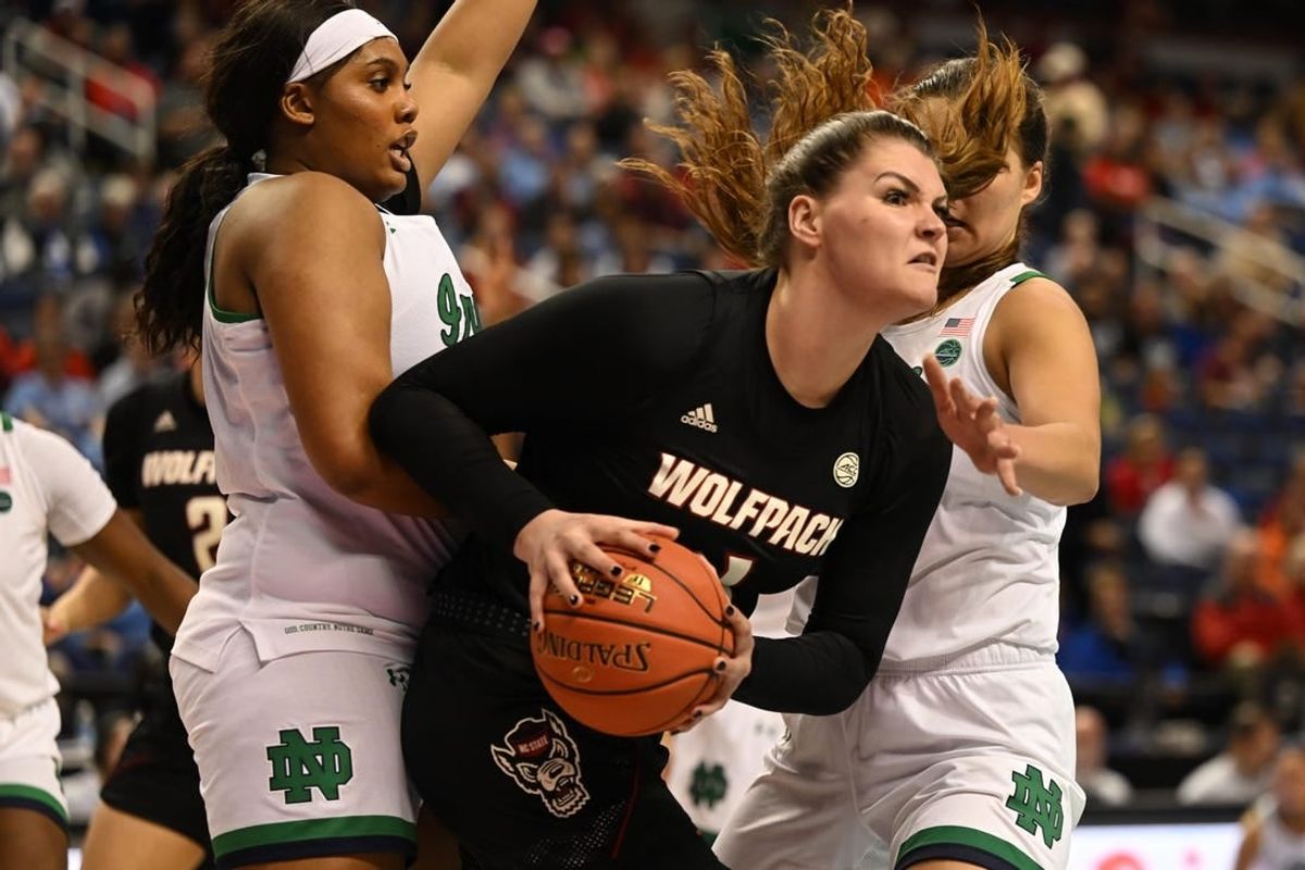 Mar 3, 2023; Greensboro, NC, USA; NC State Wolfpack center River Baldwin (1) controls the ball against Notre Dame Fighting Irish center Lauren Ebo (33) and forward Maddy Westbeld (21) during the first half at Greensboro Coliseum.