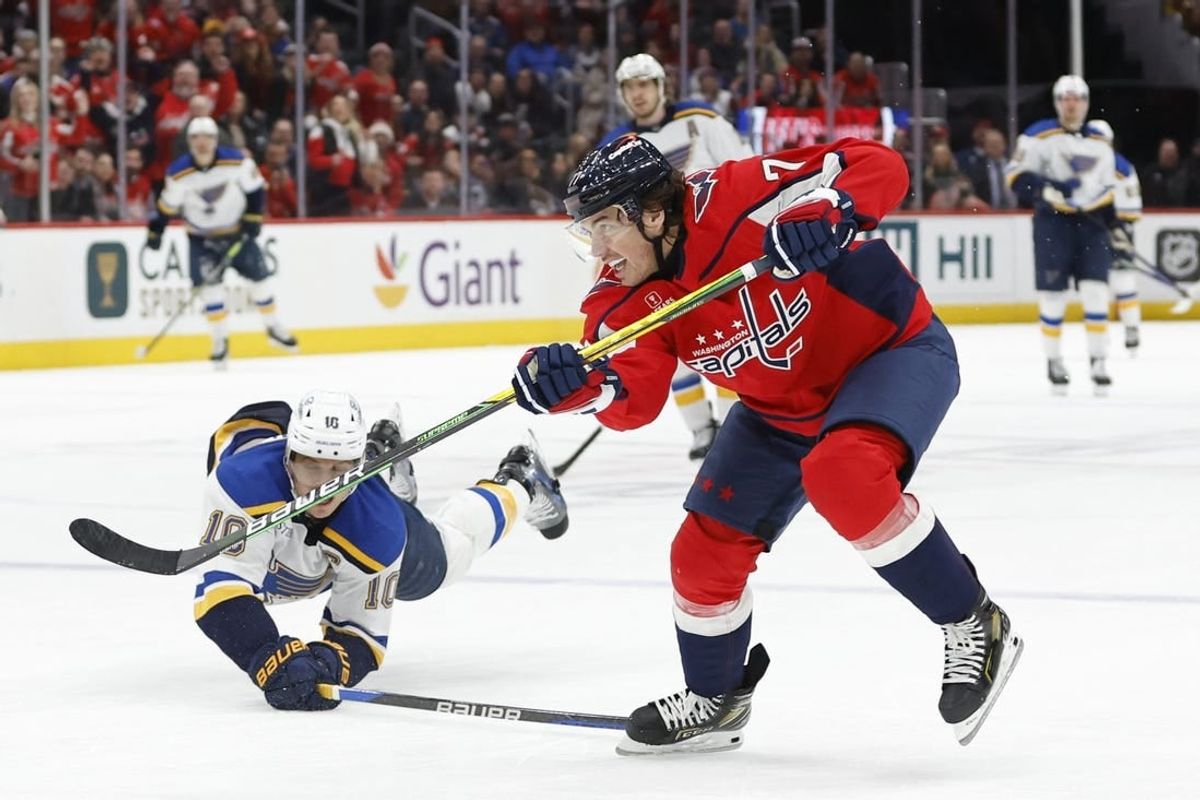 Jan 18, 2024; Washington, District of Columbia, USA; Washington Capitals right wing T.J. Oshie (77) scores an empty net goal as St. Louis Blues center Brayden Schenn (10) defends in the third period at Capital One Arena.