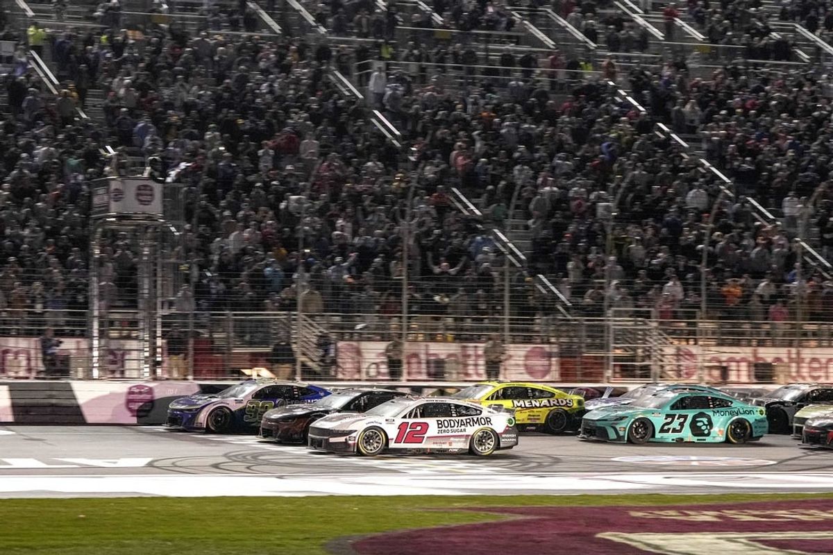 Feb 25, 2024; Hampton, Georgia, USA; NASCAR Cup Series driver Daniel Suarez (99) (near wall) beats NASCAR Cup Series driver Ryan Blaney (12) to the line to win the Ambetter Health 400 at Atlanta Motor Speedway.