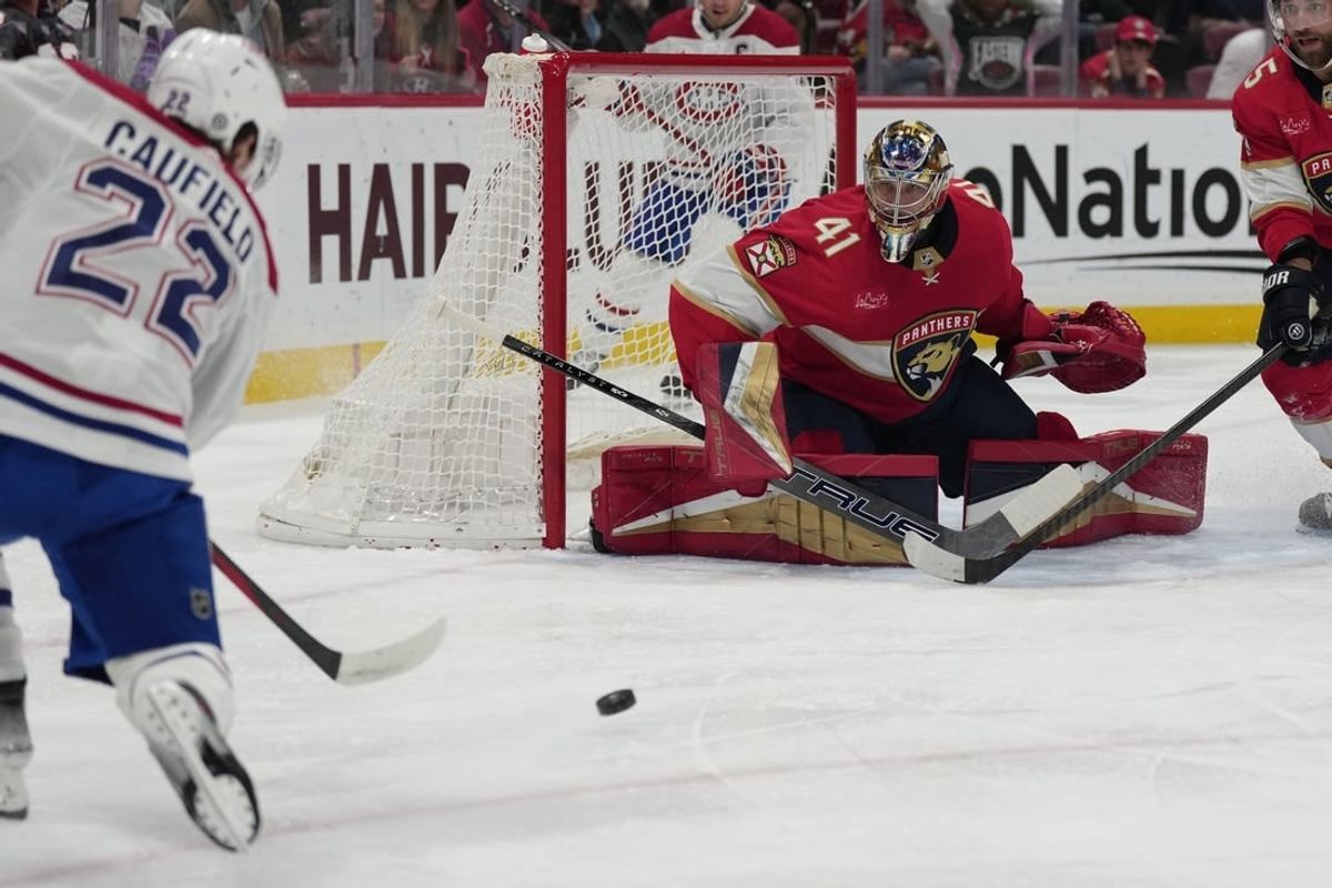 Dec 30, 2023; Sunrise, Florida, USA; Montreal Canadiens right wing Cole Caufield (22) takes a shot at goal as Florida Panthers goaltender Anthony Stolarz (41) defends during the first period at Amerant Bank Arena.