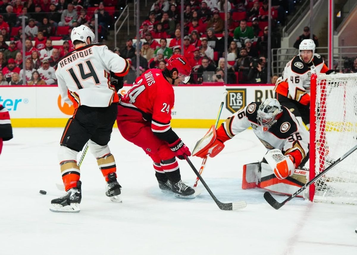 Jan 11, 2024; Raleigh, North Carolina, USA; Anaheim Ducks goaltender John Gibson (36) makes a save on Carolina Hurricanes center Seth Jarvis (24) shot during the first period at PNC Arena.