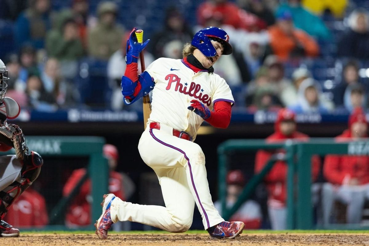 Apr 3, 2024; Philadelphia, Pennsylvania, USA; Philadelphia Phillies second baseman Bryson Stott (5) winces after an awkward swing on a foul ball during the sixth inning against the Cincinnati Reds at Citizens Bank Park.