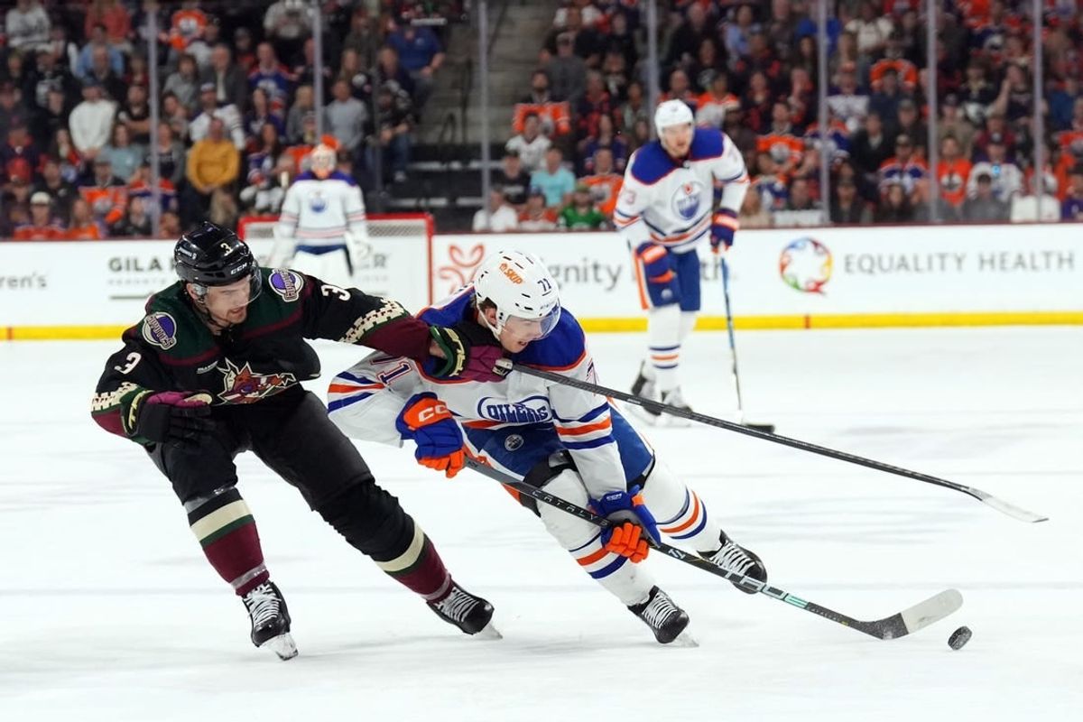 Feb 19, 2024; Tempe, Arizona, USA; Arizona Coyotes defenseman Josh Brown (3) checks Edmonton Oilers center Ryan McLeod (71) during the second period at Mullett Arena.