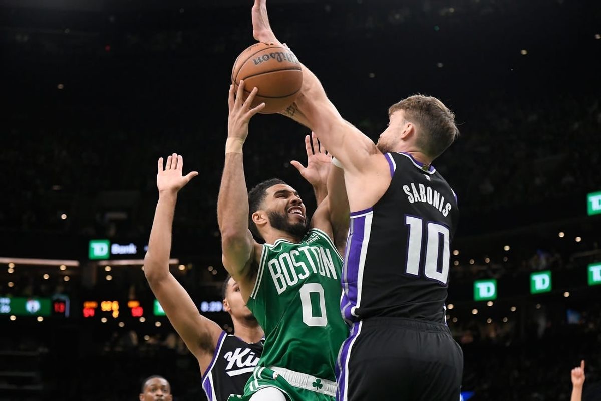 Apr 5, 2024; Boston, Massachusetts, USA; Boston Celtics forward Jayson Tatum (0)  shoots  against Sacramento Kings forward Domantas Sabonis (10) during the first half at TD Garden.