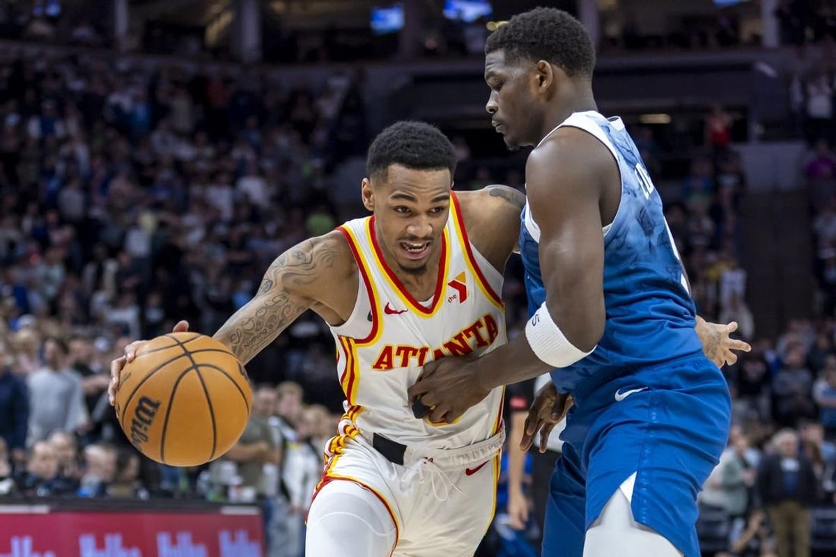 Apr 12, 2024; Minneapolis, Minnesota, USA; Atlanta Hawks guard Dejounte Murray (5) dribbles the ball around Minnesota Timberwolves guard Anthony Edwards (5) in the first half at Target Center.