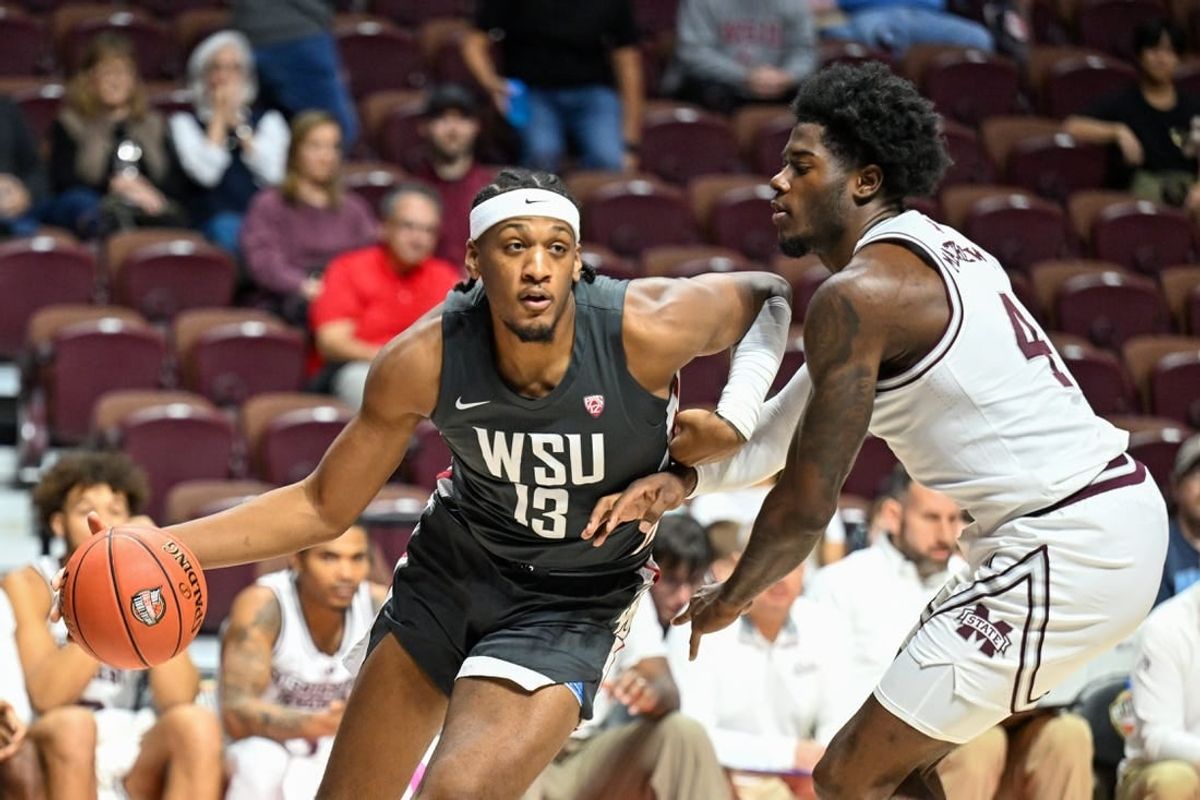 Nov 18, 2023; Uncasville, CT, USA; Washington State Cougars forward Isaac Jones (13) dribbles the ball defended by Washington State Cougars guard Shae Korpela (4) during the first half at Mohegan Sun Arena.