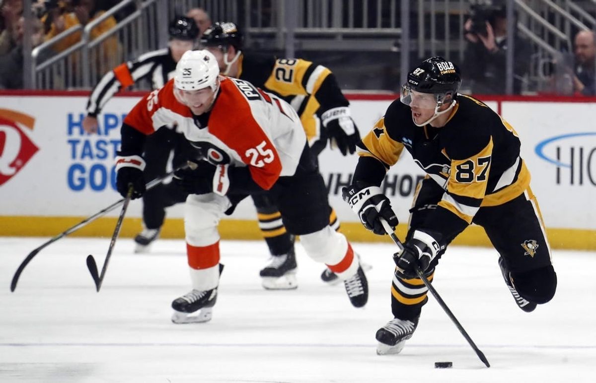 Feb 25, 2024; Pittsburgh, Pennsylvania, USA;  Pittsburgh Penguins center Sidney Crosby (87) controls the puck against the Philadelphia Flyers during the second period at PPG Paints Arena.