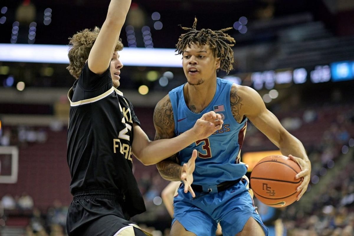 Jan 9, 2024; Tallahassee, Florida, USA; Wake Forest Demon Deacons forward Zach Keller (25) defends a drive by Florida State Seminoles guard Cam Corhen (3) during the first half at Donald L. Tucker Center.