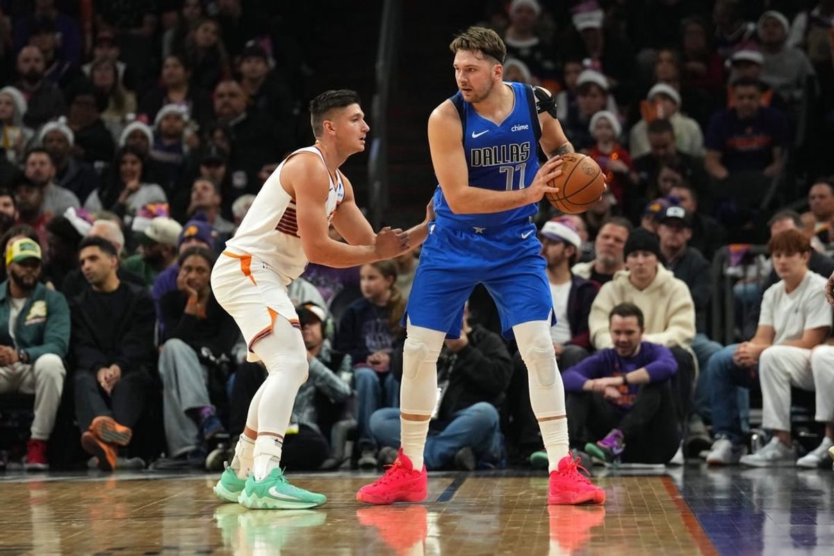 Dec 25, 2023; Phoenix, Arizona, USA; Phoenix Suns guard Grayson Allen (8) guards Dallas Mavericks guard Luka Doncic (77) during the first half at Footprint Center.
