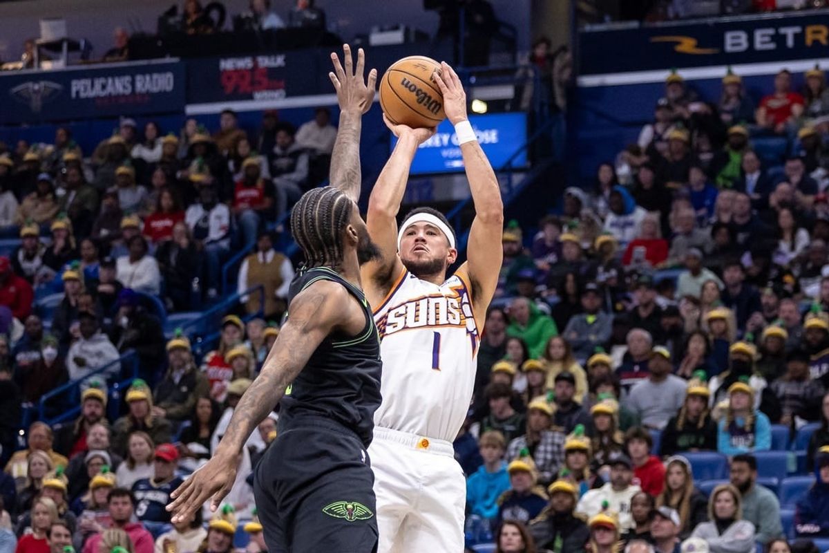 Jan 19, 2024; New Orleans, Louisiana, USA;  Phoenix Suns guard Devin Booker (1) shoots against New Orleans Pelicans forward Naji Marshall (8) during the first half at Smoothie King Center.