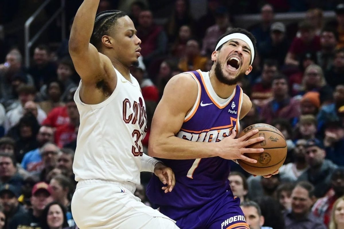 Mar 11, 2024; Cleveland, Ohio, USA; Phoenix Suns guard Devin Booker (1) drives to the basket against Cleveland Cavaliers forward Isaac Okoro (35) during the first half at Rocket Mortgage FieldHouse.