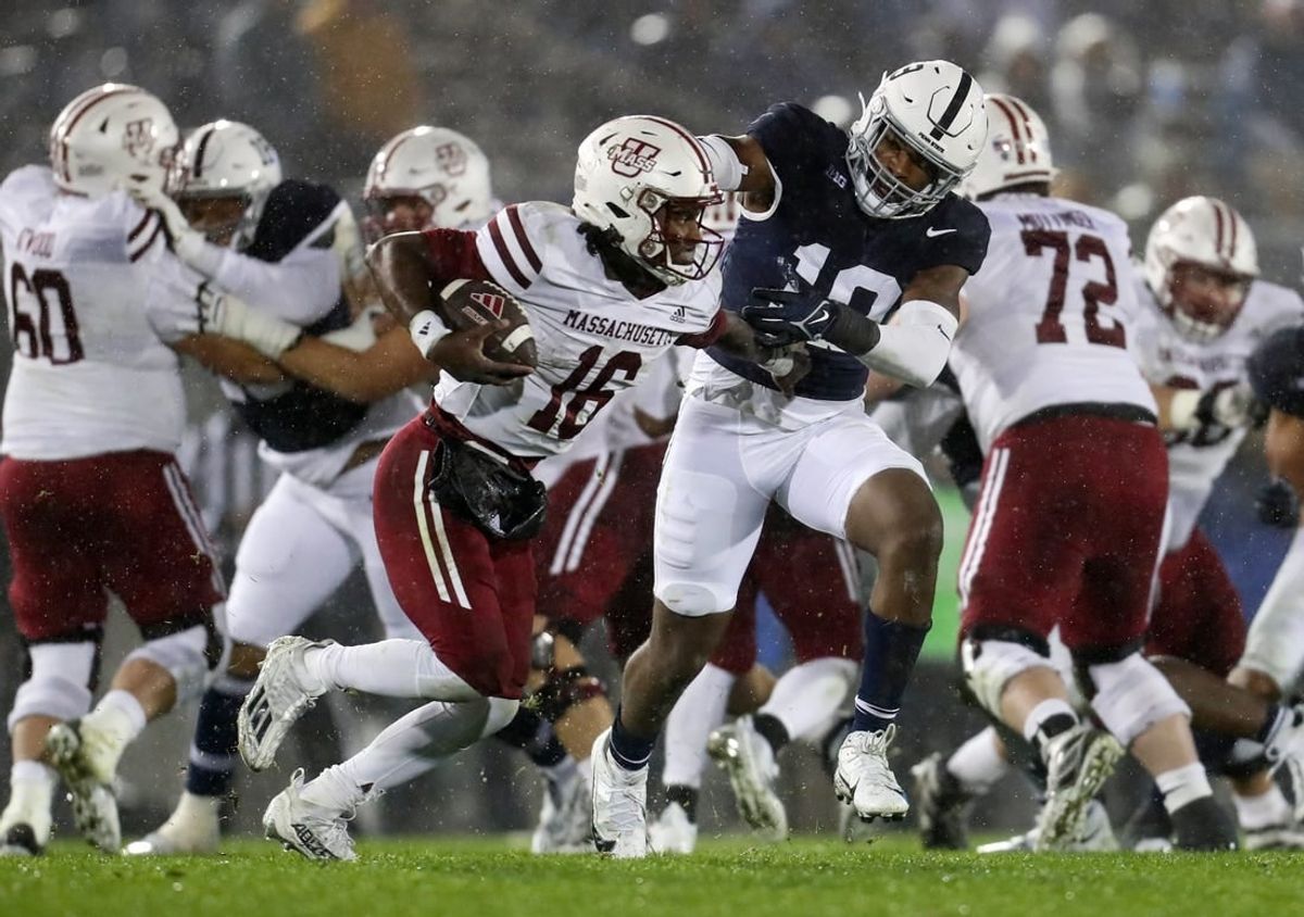 Oct 14, 2023; University Park, Pennsylvania, USA; Penn State Nittany Lions defensive end Jameial Lyons (19) pressures Massachusetts Minutemen quarterback Ahmad Haston (16) during the fourth quarter at Beaver Stadium. Penn State defeated Massachusetts 63-0.