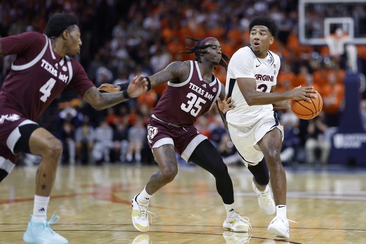 Nov 29, 2023; Charlottesville, Virginia, USA; Virginia Cavaliers guard Reece Beekman (2) drives to the basket past Texas A&M Aggies guard Manny Obaseki (35) in the second half at John Paul Jones Arena.
