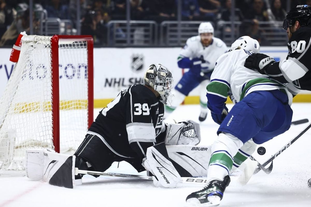 Apr 6, 2024; Los Angeles, California, USA; Los Angeles Kings goaltender Cam Talbot (39) attempts to make a save against Vancouver Canucks right wing Brock Boeser (6)  during the first period of a game at Crypto.com Arena.