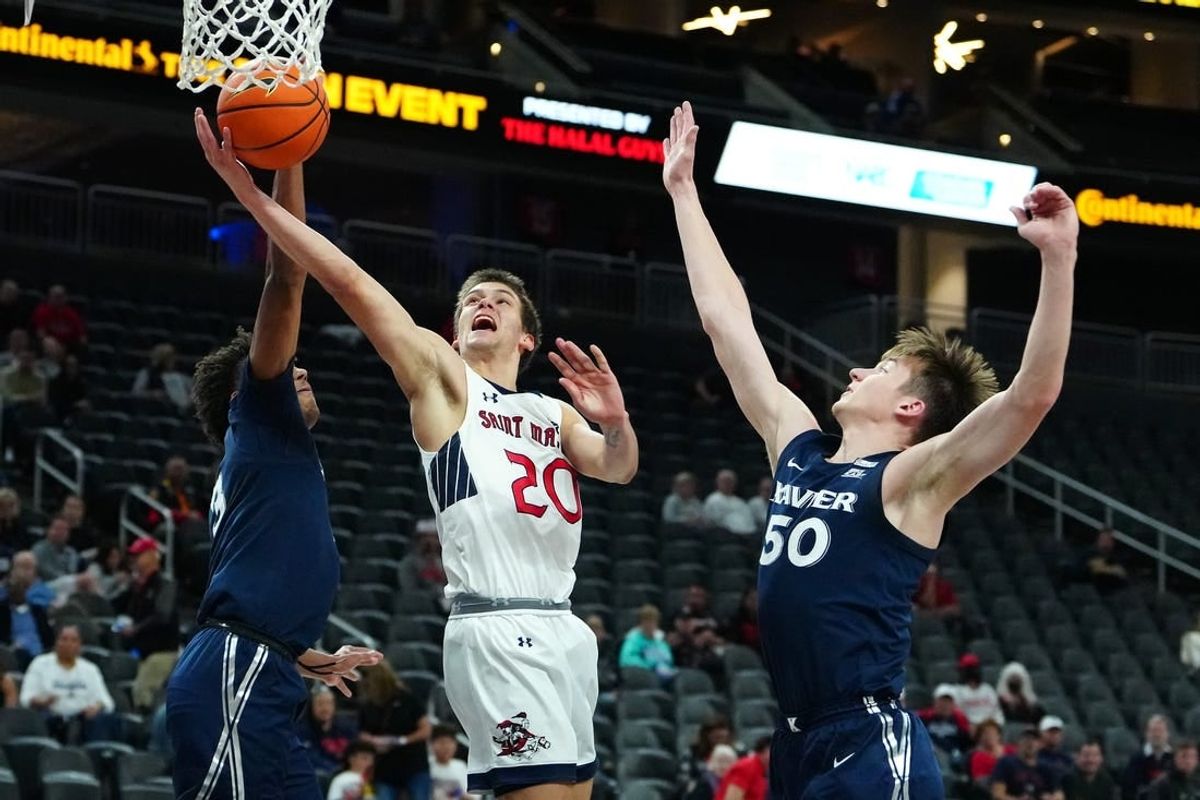 Nov 19, 2023; Las Vegas, NV, USA; St. Mary's Gaels guard Aidan Mahaney (20) shoots between Xavier Musketeers guard Dailyn Swain (3) and forward Gytis Nemeiksa (50) during the first half at T-Mobile Arena.