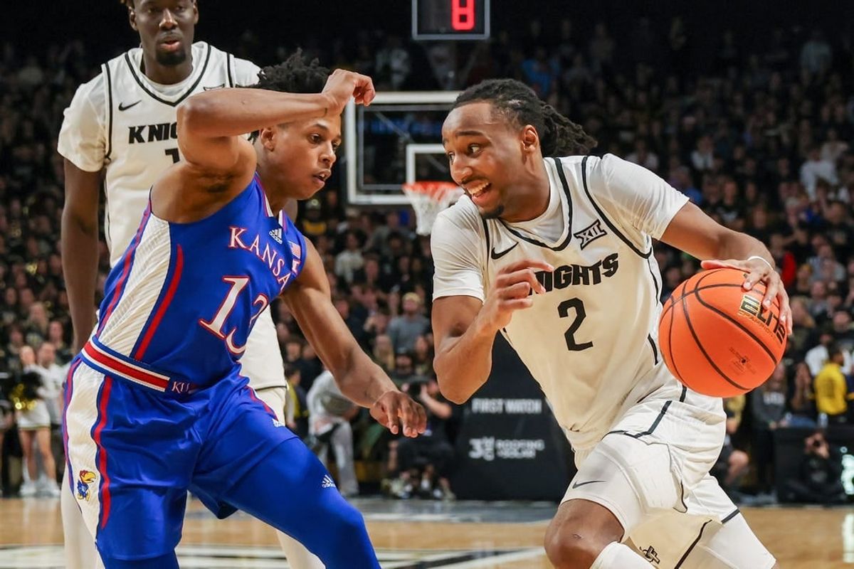 Jan 10, 2024; Orlando, Florida, USA; UCF Knights guard Shemarri Allen (2) drives to the basket around Kansas Jayhawks guard Elmarko Jackson (13) during the second half at Addition Financial Arena.