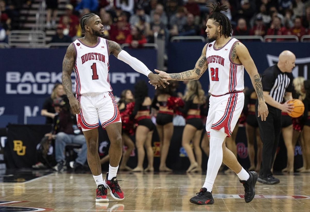 Mar 15, 2024; Kansas City, MO, USA; Houston Cougars guard Jamal Shead (1) celebrates with guard Emanuel Sharp (21) in the second half against the Texas Tech Red Raiders at T-Mobile Center.