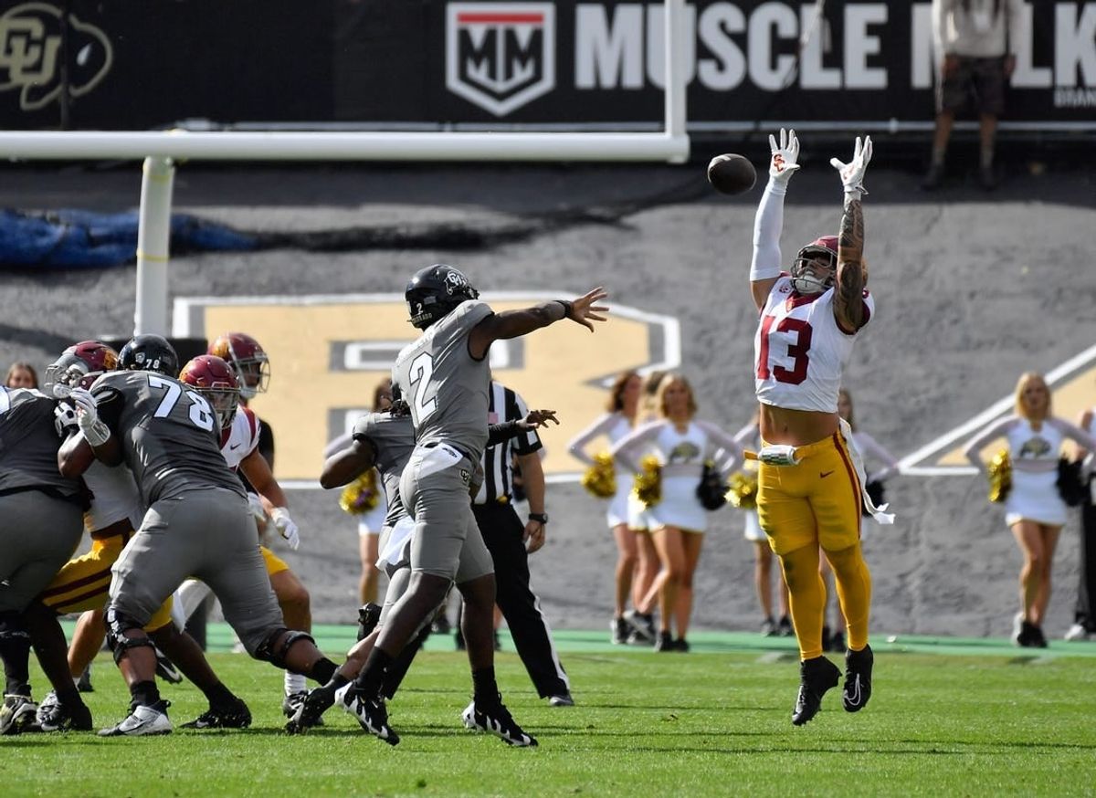 Sep 30, 2023; Boulder, Colorado, USA; Colorado Buffaloes quarterback Shedeur Sanders (2) gets his pass knocked down by USC Trojans linebacker Mason Cobb (13) during the first quarter at Folsom Field.