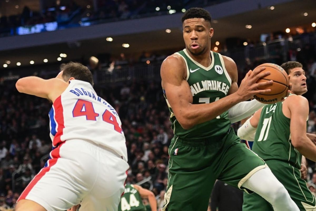 Dec 16, 2023; Milwaukee, Wisconsin, USA; Milwaukee Bucks forward Giannis Antetokounmpo (34) grabs a rebound against Detroit Pistons forward Bojan Bogdanovic (44) in the first quarter at Fiserv Forum.