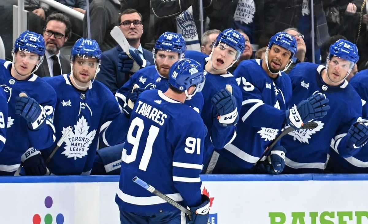 Feb 5, 2024; Toronto, Ontario, CAN;   Toronto Maple Leafs forward John Tavares (91) celebrates with team mates at the bench after scoring a goal against the New York Islanders in the third period at Scotiabank Arena.